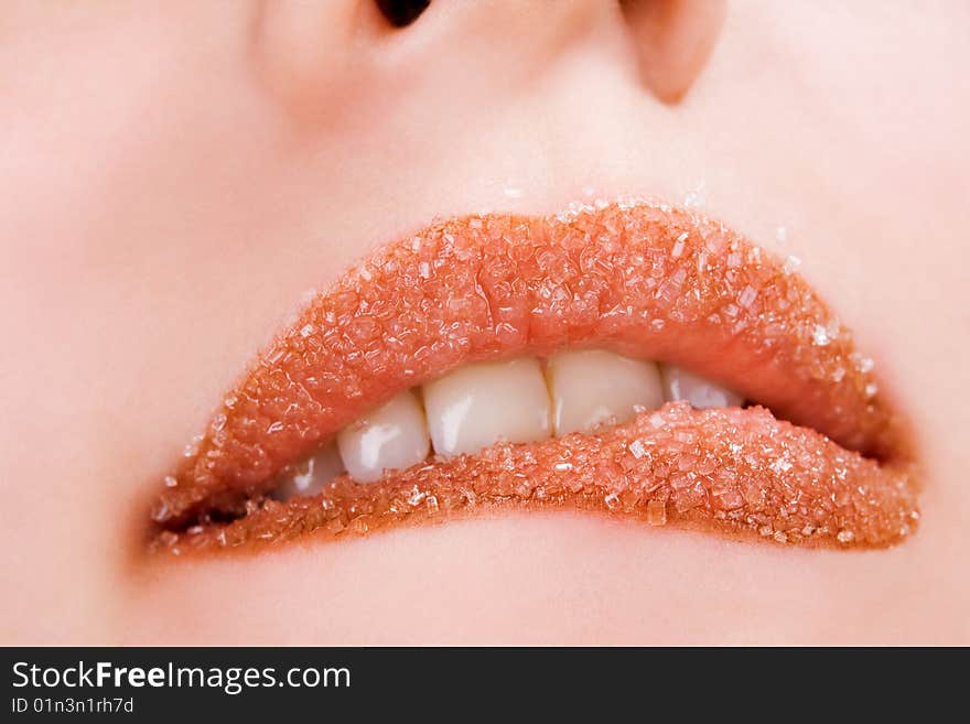 Woman's red lips coated with scattered sugar. Woman's red lips coated with scattered sugar