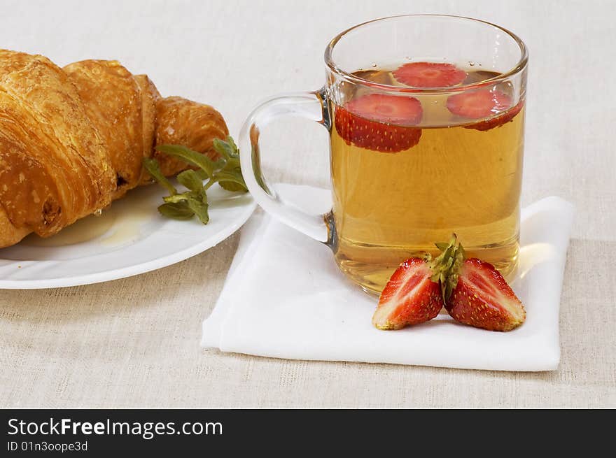 Breakfast with tea and croissant