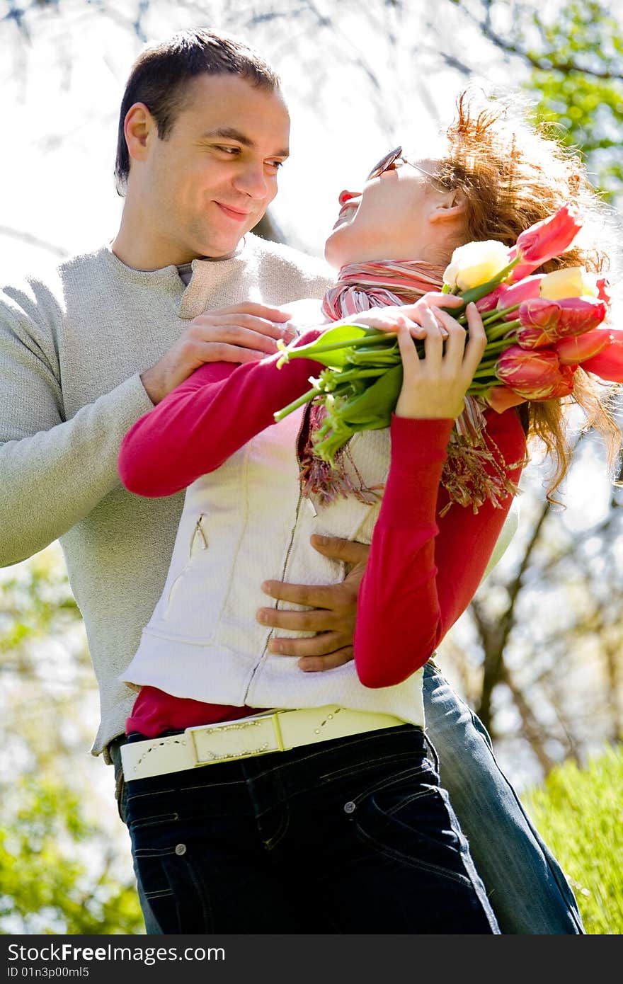 Happy young couple with red tulips. Happy young couple with red tulips