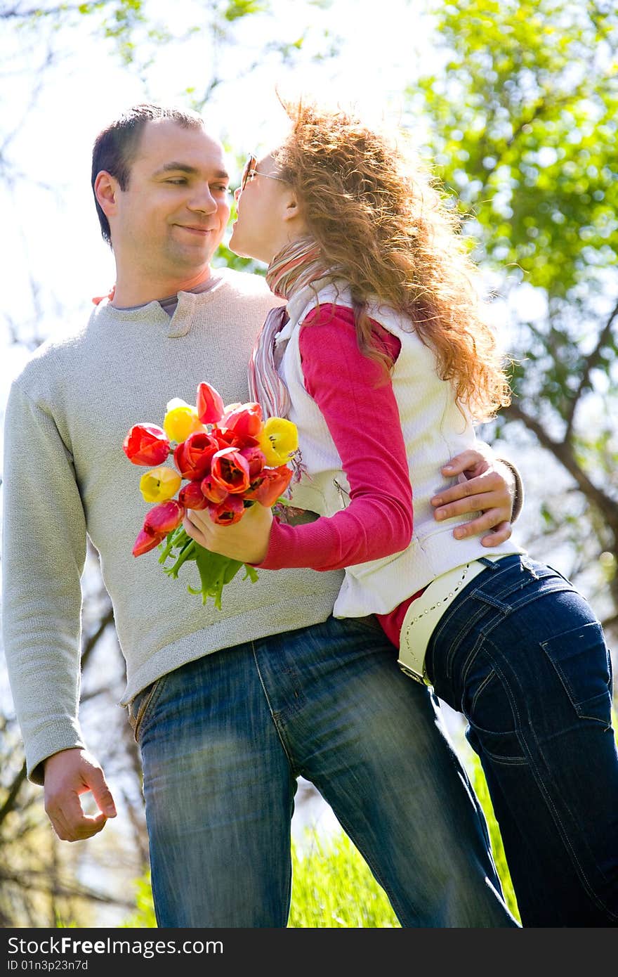 Happy young couple with red tulips. Happy young couple with red tulips