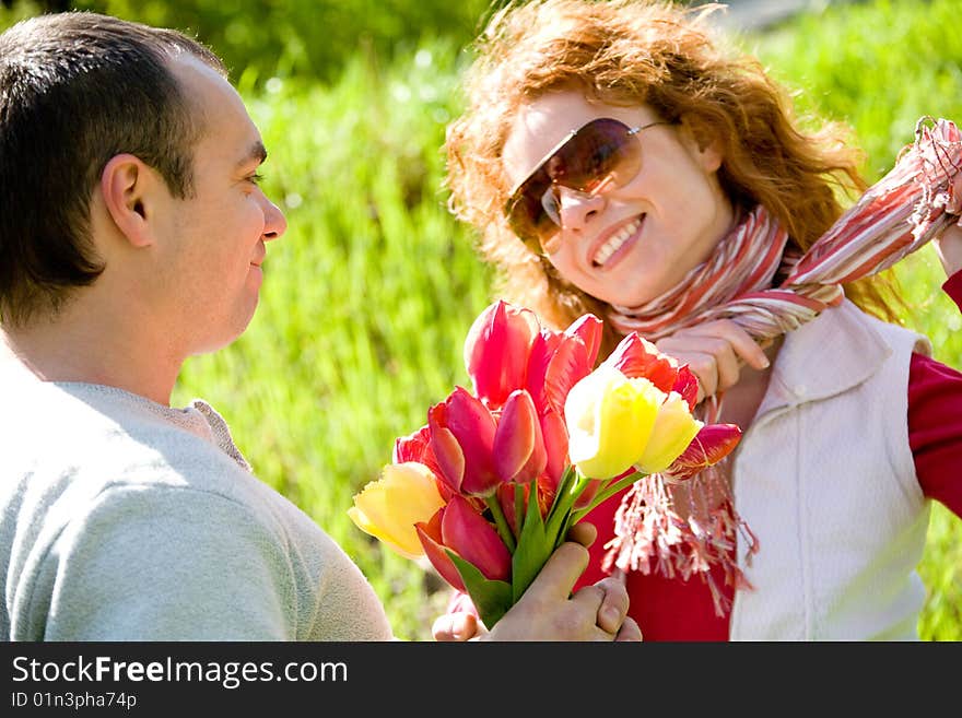 Happy young couple with red tulips. Happy young couple with red tulips