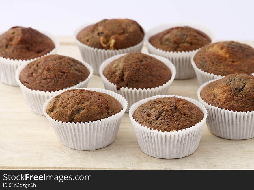 Fresh baked Muffins on a wooden Board