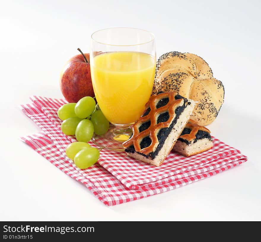 Still life of a glass of juice, pastry and fruit. Still life of a glass of juice, pastry and fruit