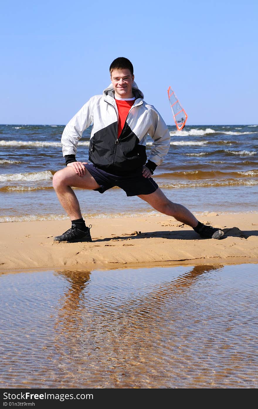 Young man doing exercise at beach