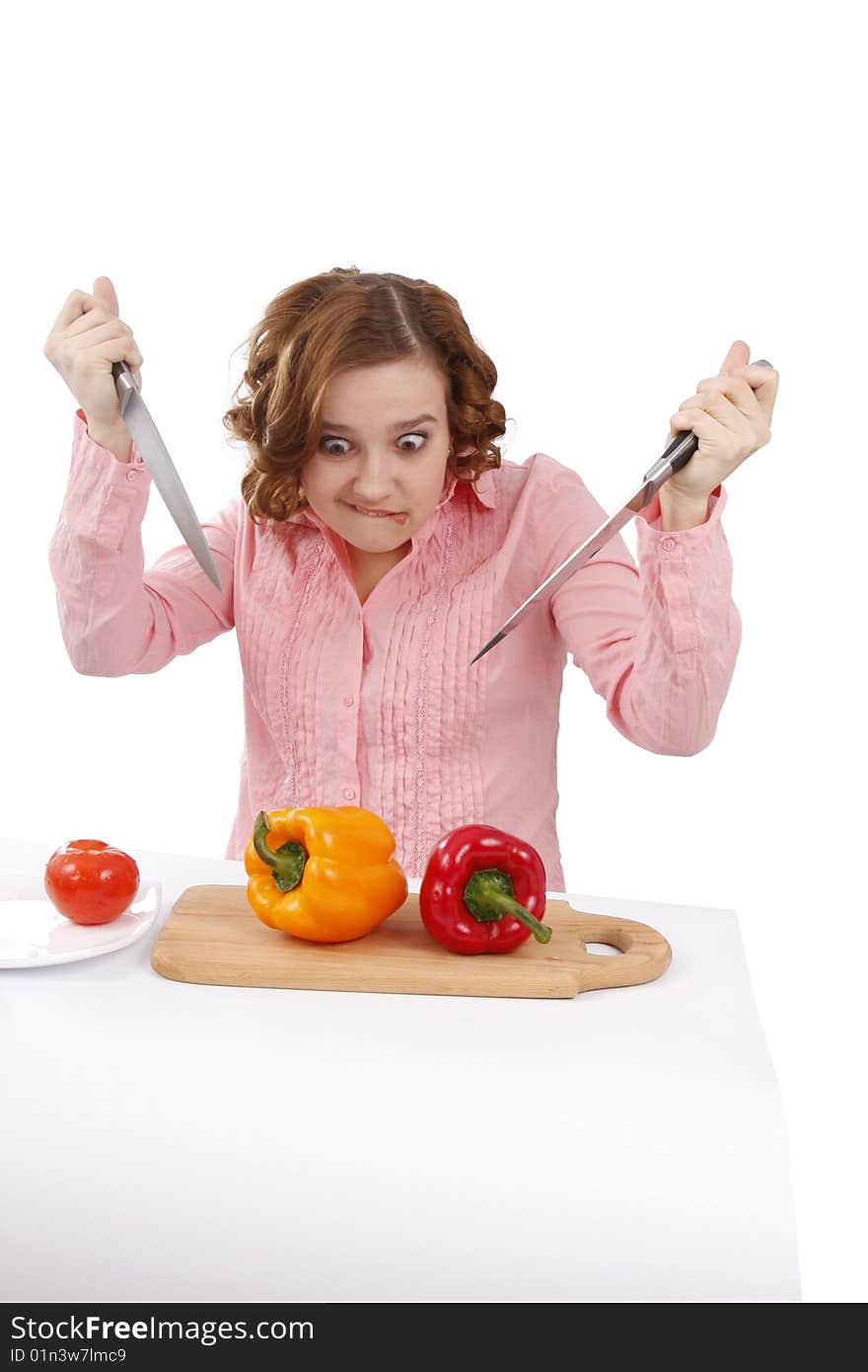 Beautiful young woman with fresh vegetables. Pretty girl with pepper.  Housewife with sweet peppers and knifes. Isolated over white background. Beautiful young woman with fresh vegetables. Pretty girl with pepper.  Housewife with sweet peppers and knifes. Isolated over white background.