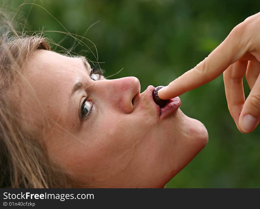 Young Girl eating a cherry. Young Girl eating a cherry