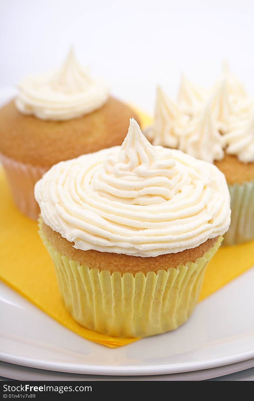 Trio of yummy lemon cupcakes topped with fresh buttercreme frosting