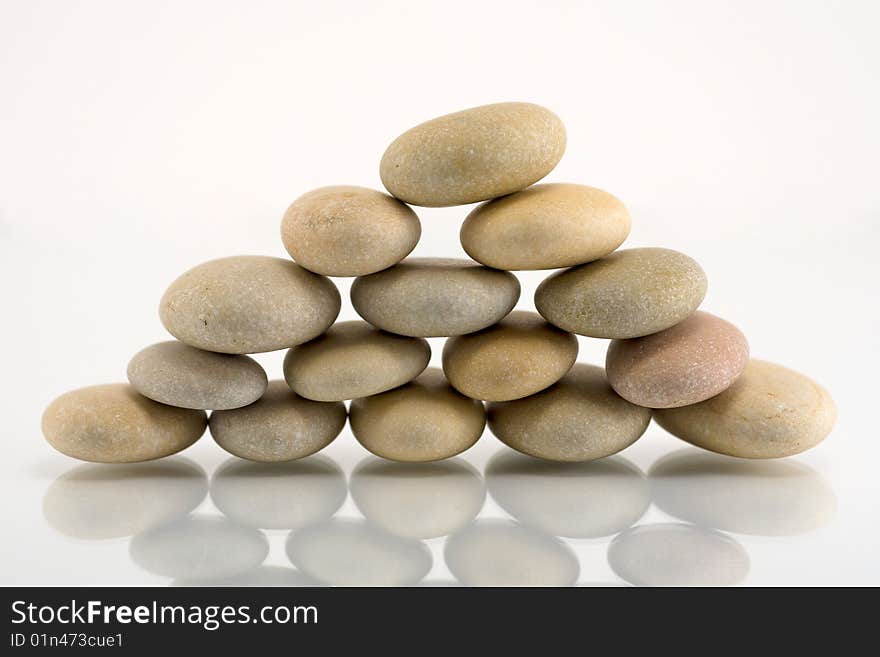 Pebble pyramid on white background