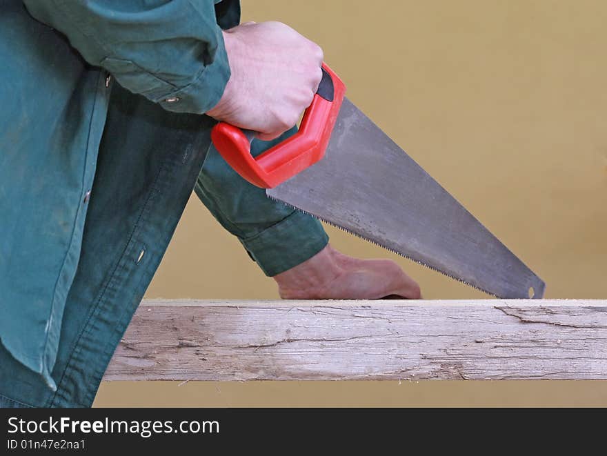 Arm With Handsaw Cutting Wood