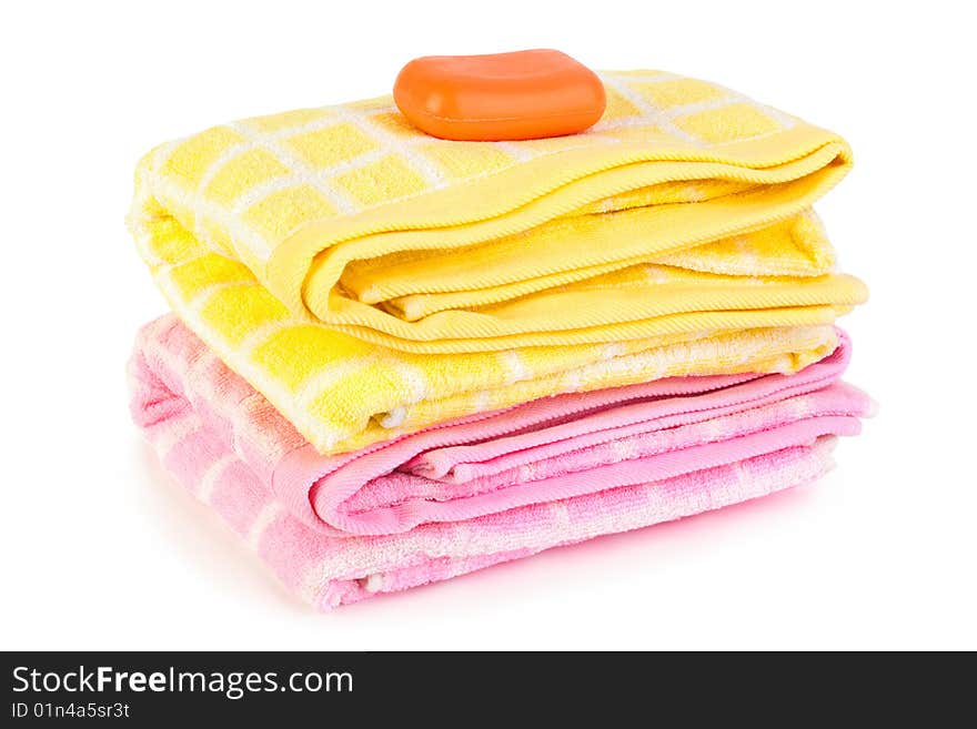 Towels and piece of soap isolated on white background. Towels and piece of soap isolated on white background