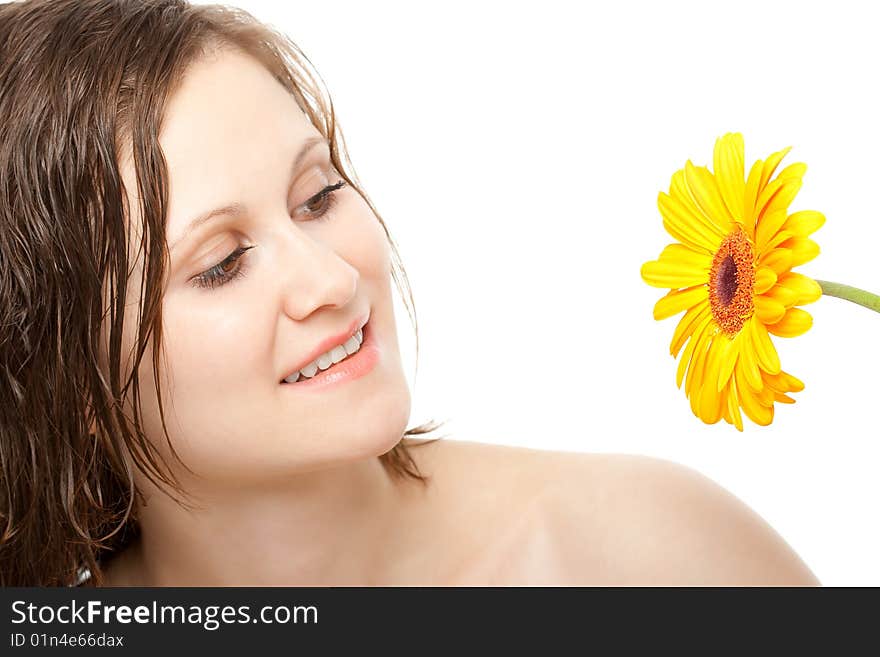 Smiling beautiful woman looking to yellow gerber. Smiling beautiful woman looking to yellow gerber