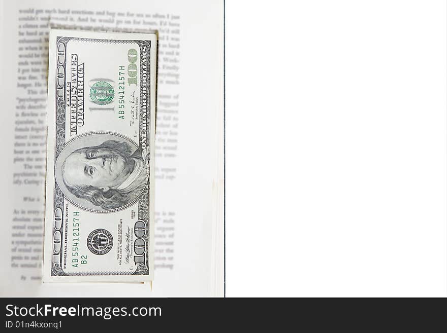 One hundred dollar bills hidden inside prop book on white background. One hundred dollar bills hidden inside prop book on white background