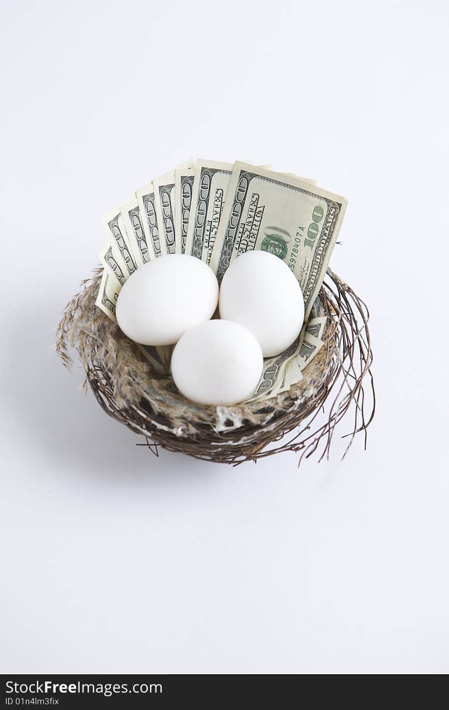 One hundred dollar bills in nest with eggs. One hundred dollar bills in nest with eggs