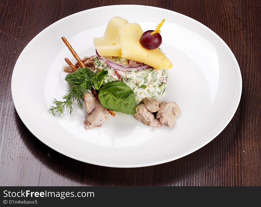 Salad with liver of codfish on browm table with clipping path