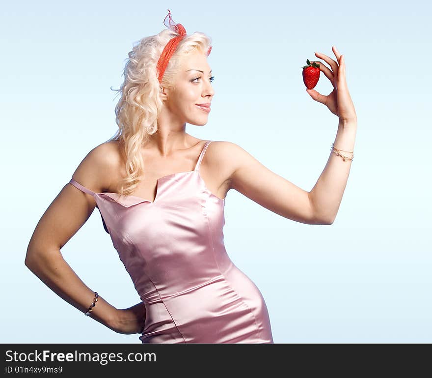 Young woman looking at strawberry