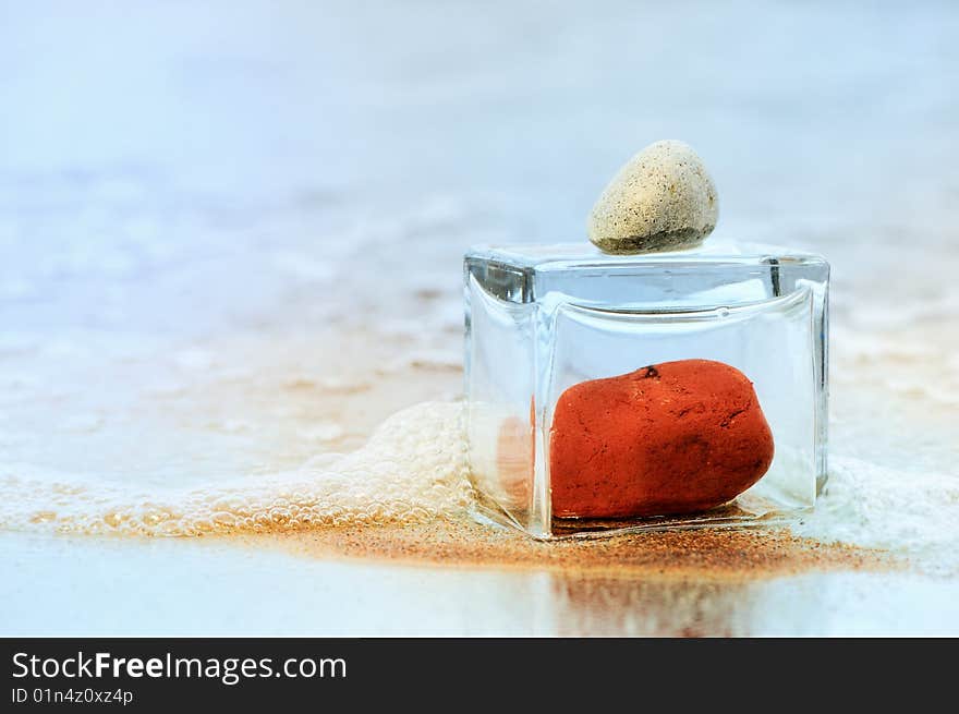 Red stone in the glass insulation of the white pebble. Red stone in the glass insulation of the white pebble