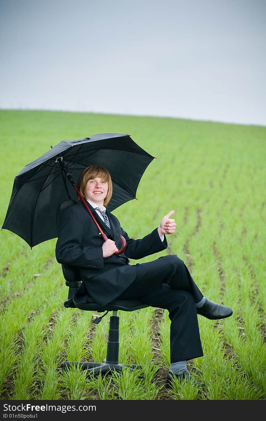 Smiling businessman with umbrella