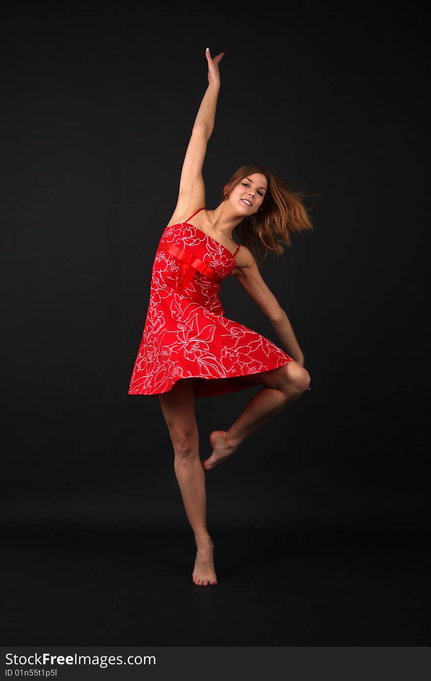 Elegant young flexible woman in red-white outfit