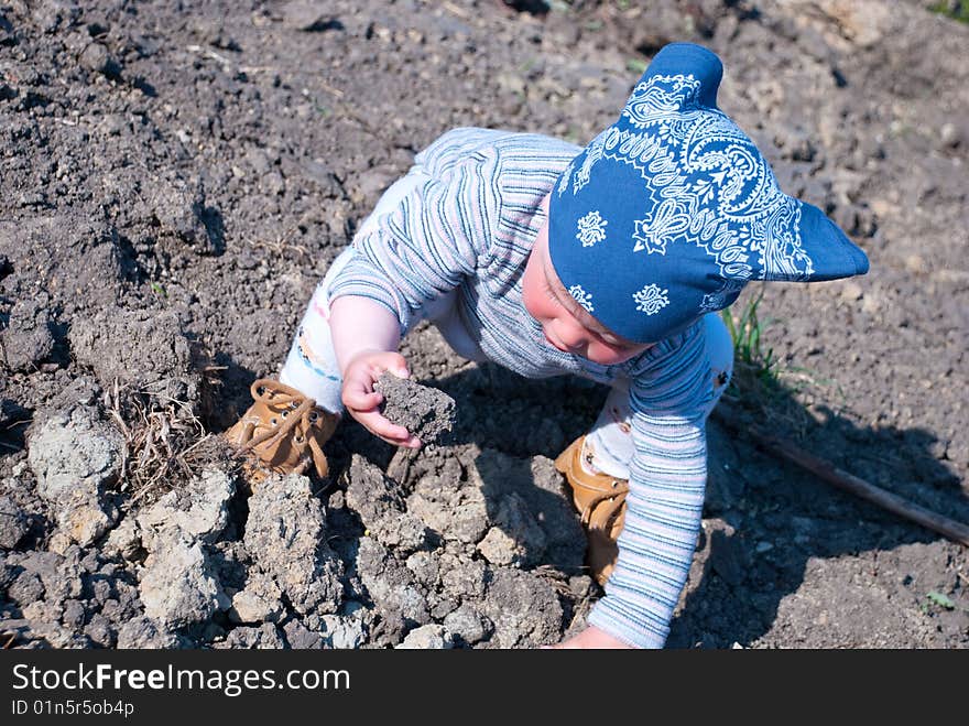 Baby research the stones on a ground. Baby research the stones on a ground