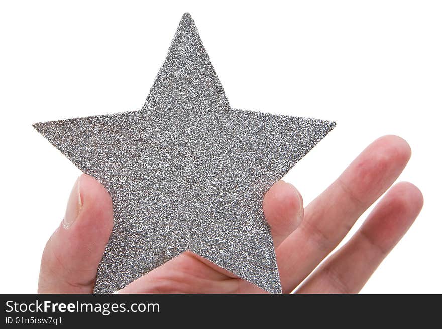 Silvery star in a hand isolated on a white background