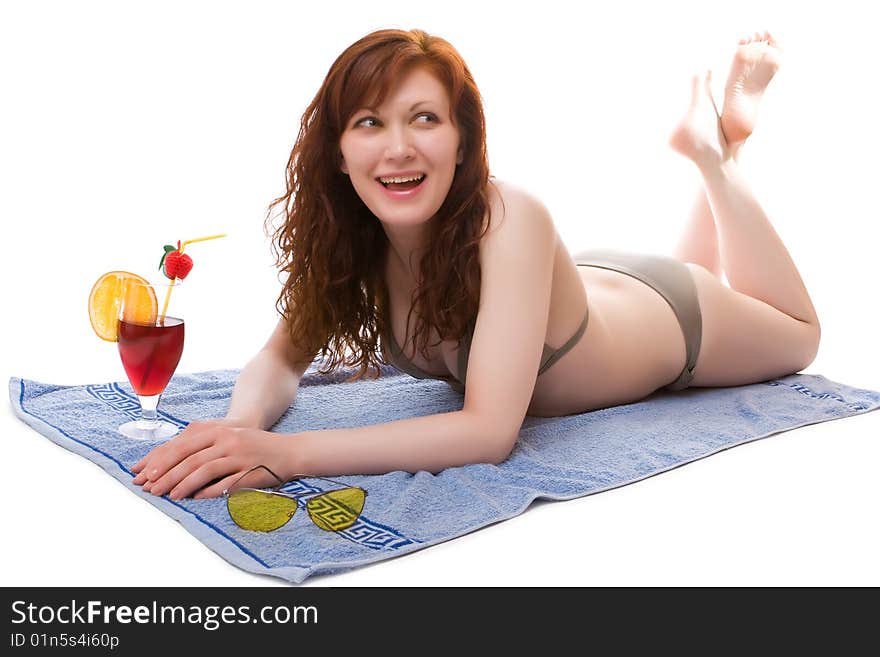 Beautiful girl on a beach towel with a cocktail. Beautiful girl on a beach towel with a cocktail