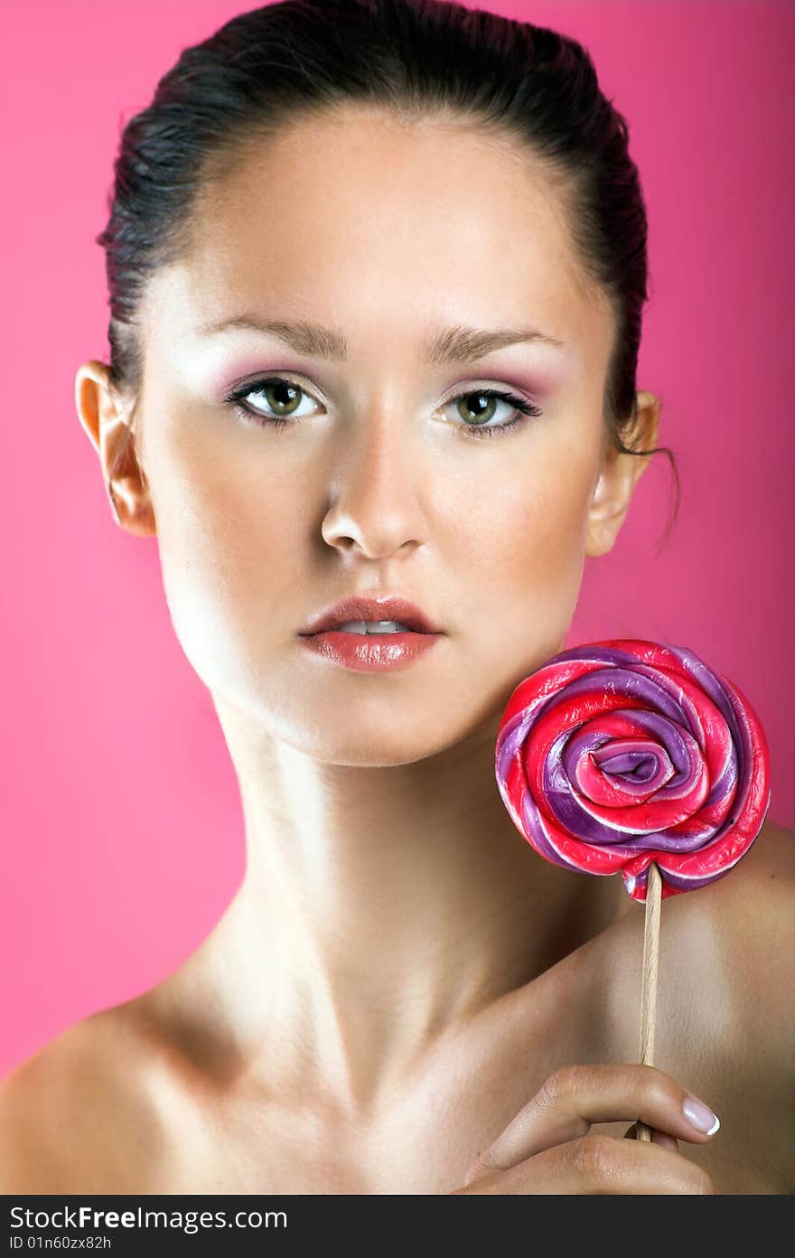 Beauty portrait of a young woman with a lollipop. Beauty portrait of a young woman with a lollipop