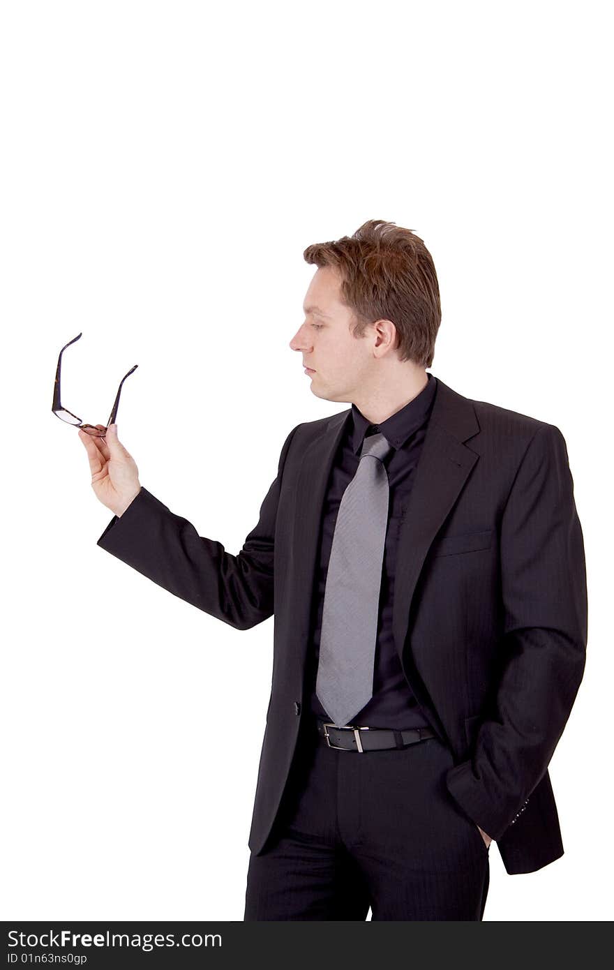 A young business man is holding his glasses while presenting something. A young business man is holding his glasses while presenting something