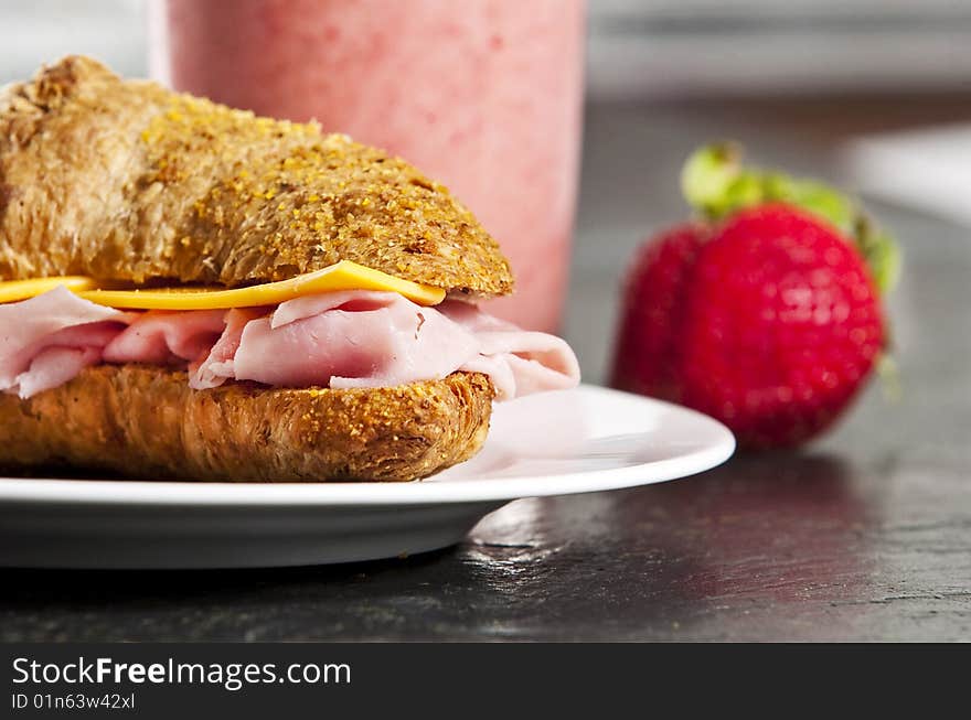 Continental breakfast with croissant and strawberry smoothie