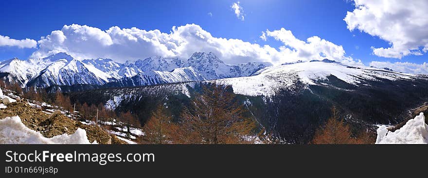 Scenic view of snow capped Meili mountain with cloudscape in foreground, Yunnan province, China. Scenic view of snow capped Meili mountain with cloudscape in foreground, Yunnan province, China.