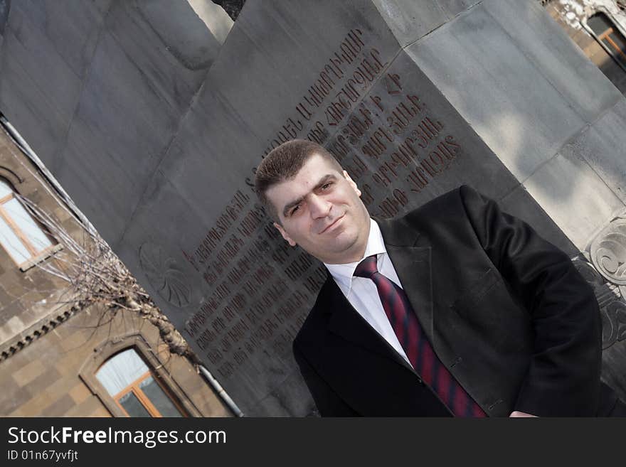 Portrait of man on monument background in Echmiadzin