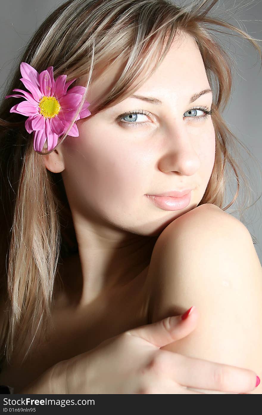 Beautiful young woman with pink flower. Beautiful young woman with pink flower