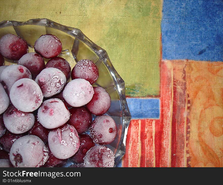 Frozen cherries on a glass plate