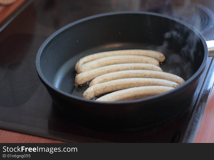 Frying sausage in the pan. Frying sausage in the pan.