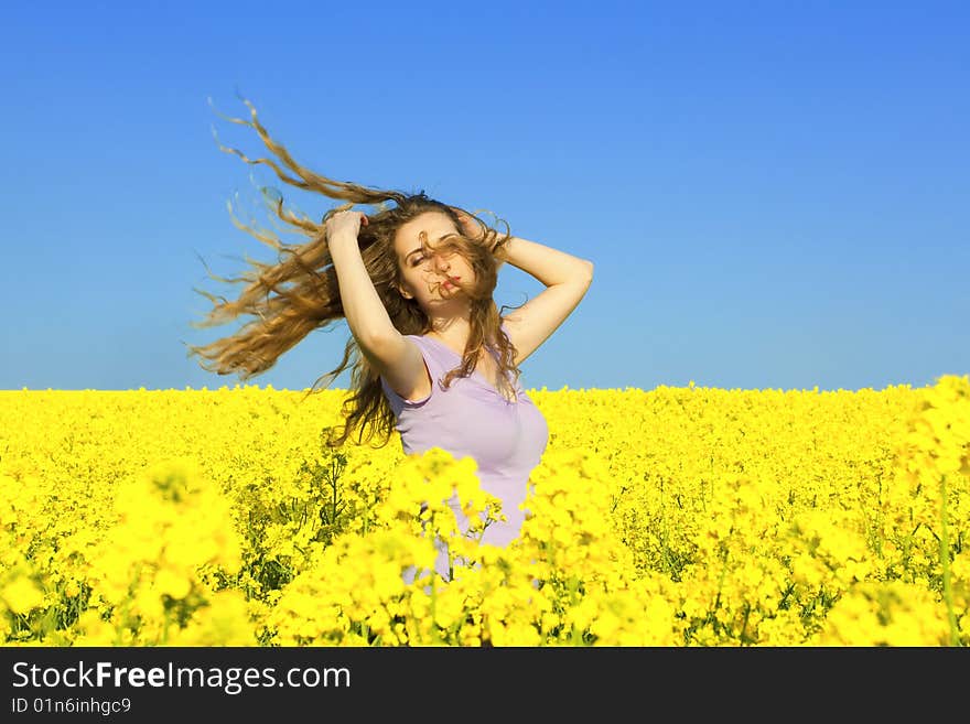 woman in rape(canola) field enjoying the open air. woman in rape(canola) field enjoying the open air