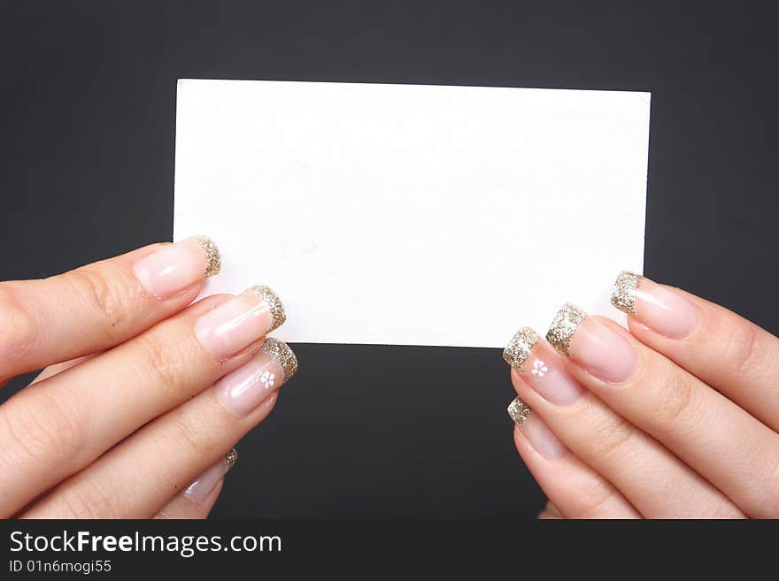 Woman holding card on black background