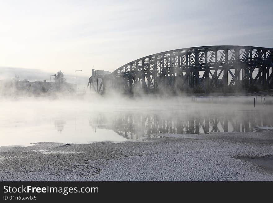 Very cold day, view over a river and bridge