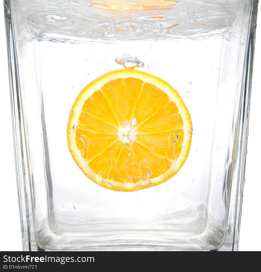 Fresh orange slice splashing into transparent water. Fresh orange slice splashing into transparent water