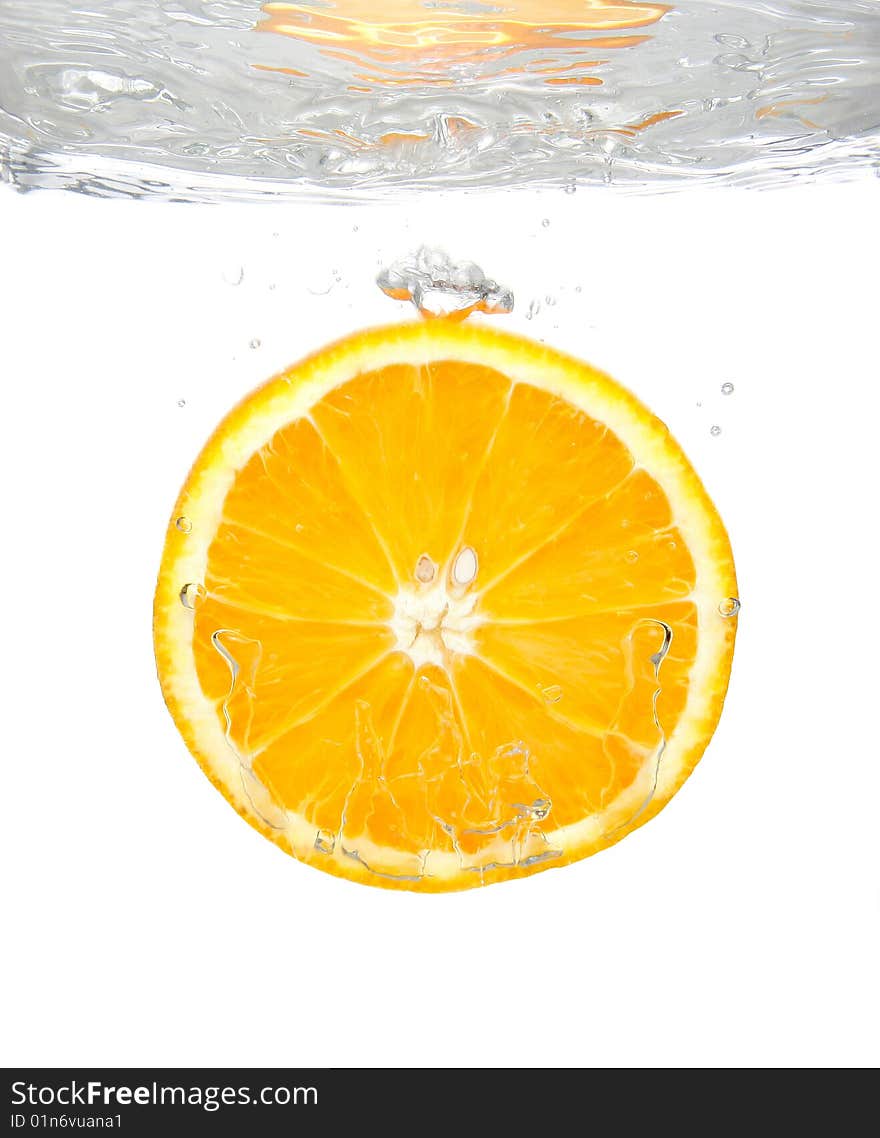 Fresh orange slice splashing into transparent water. Fresh orange slice splashing into transparent water