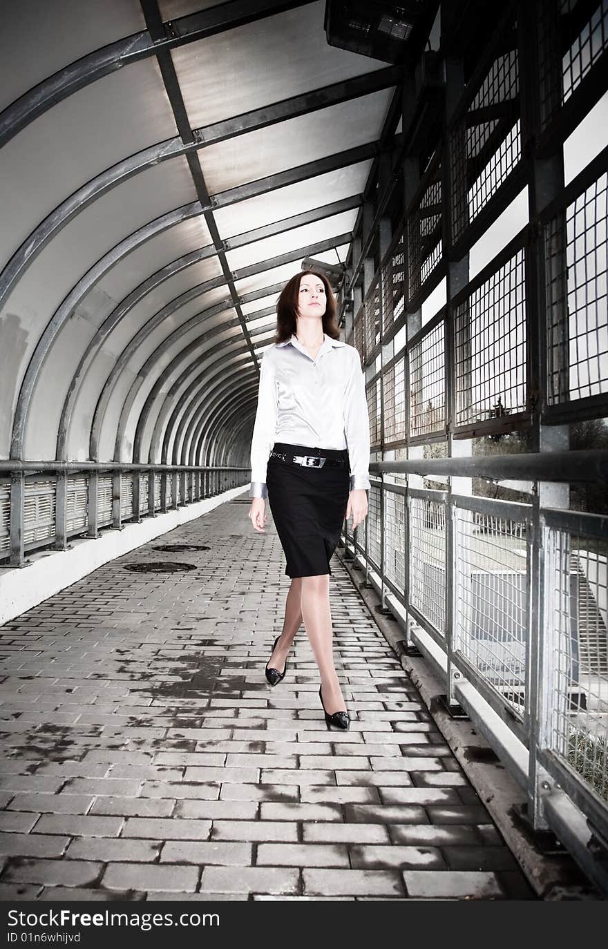 Beautiful Businesswoman Walking On The Pedestrian Bridge.