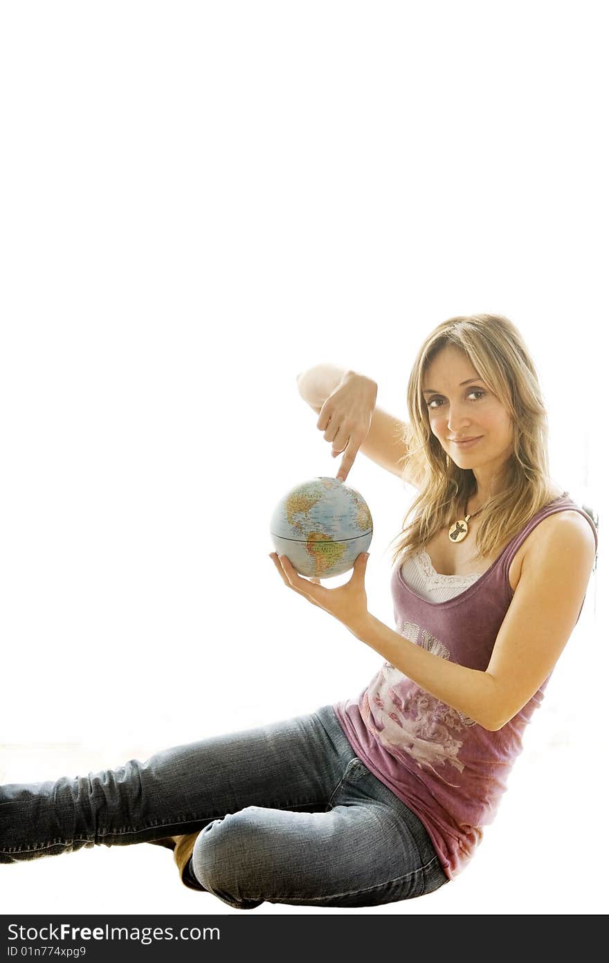 Young woman holding a small globe in her hand. Young woman holding a small globe in her hand.