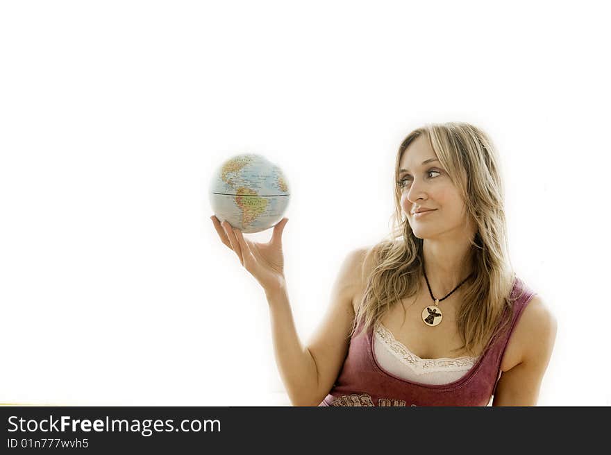 Young woman holding a small globe in her hand. Young woman holding a small globe in her hand.