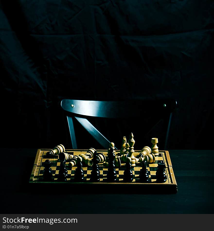 Chess figures on a chess board battle