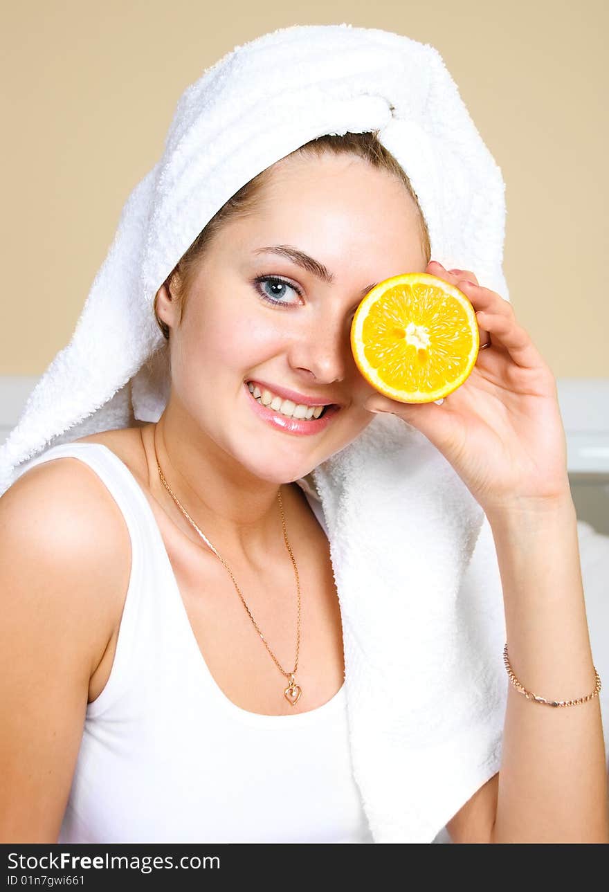 Pretty woman eating oranges