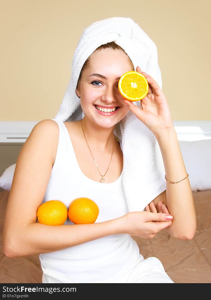 Pretty woman eating oranges