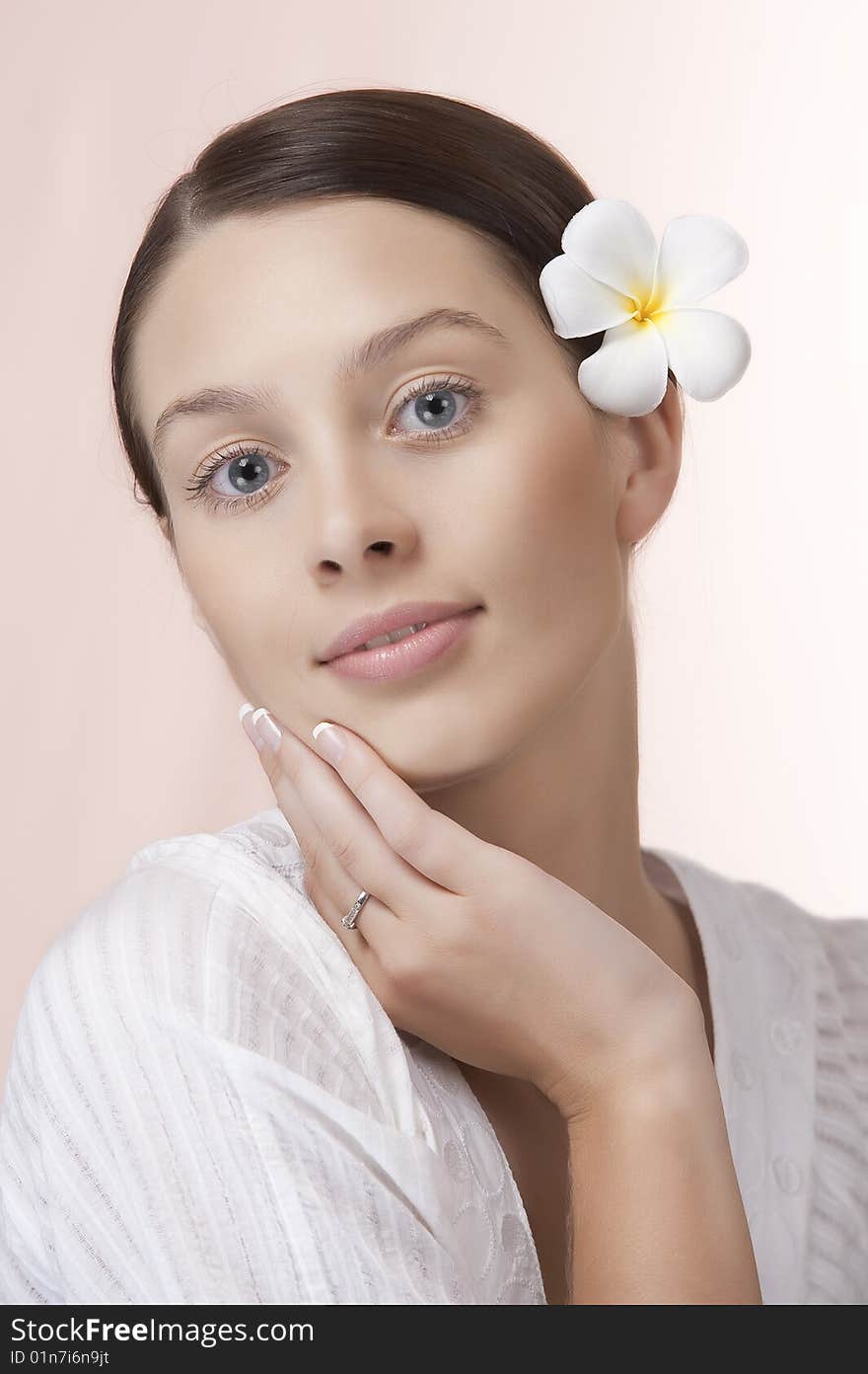 Portrait of young beautiful woman on pink background