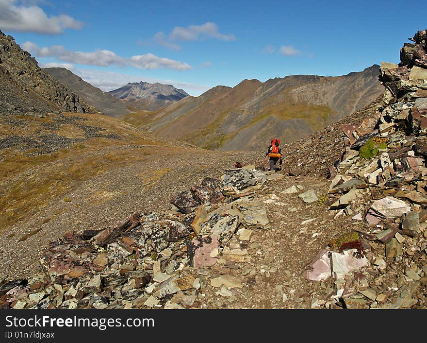 A lone backpacker hikes the trail to Grizzly Lake in central Yukon Territory, Canada. A lone backpacker hikes the trail to Grizzly Lake in central Yukon Territory, Canada