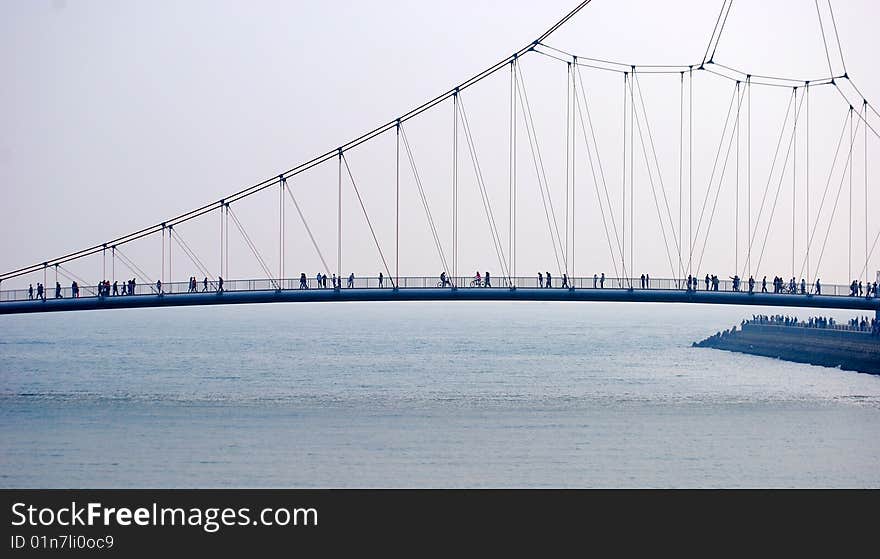 Bridge, side view. Crowd of people.