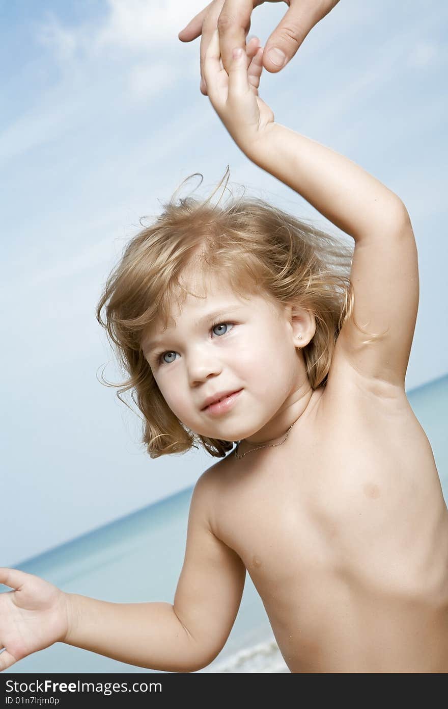 Portrait of nice little girl led by finger around  the  beach. Portrait of nice little girl led by finger around  the  beach