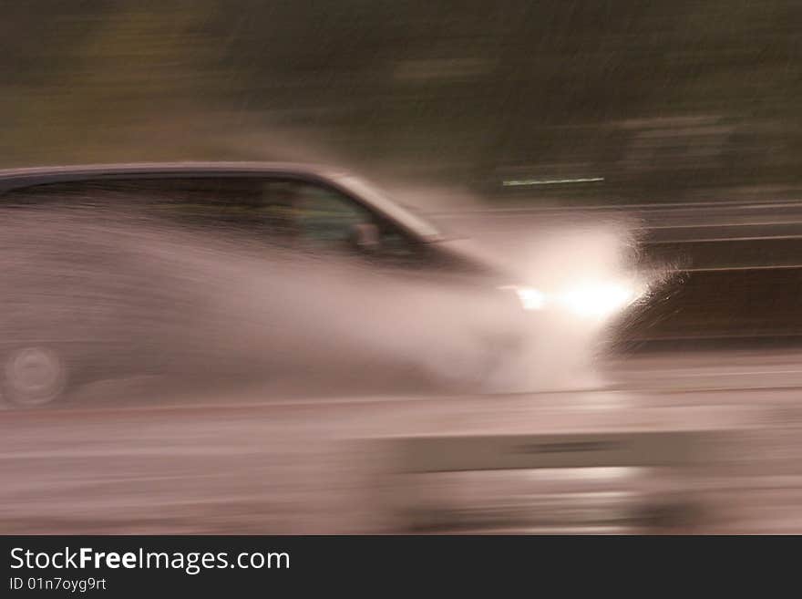 Car on the street with splashing water