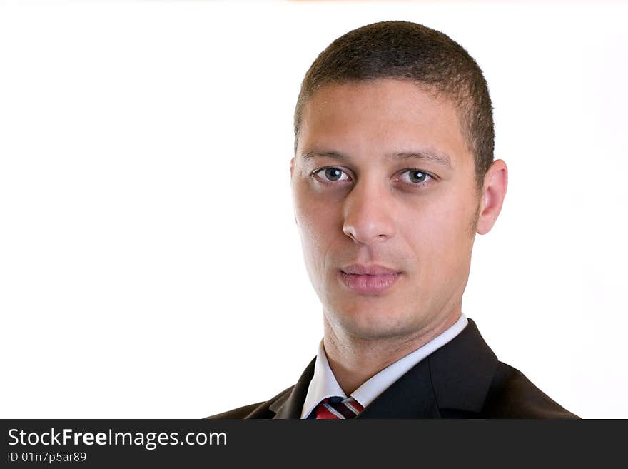 Businessman looks self confident into camera on white background